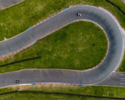 Aerial view of a winding asphalt race track with two cars