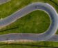 Aerial view of a winding asphalt race track with two cars