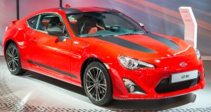 Brussels, Belgium - Januari 12, 2016: Red Toyota GT 86 or just 86 coupe sports car front view. The car is on display during the 2016 Brussels Motor Show. The car is displayed on a motor show stand, with lights reflecting off of the body.